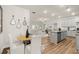 Open-concept kitchen boasts gray cabinets, granite countertops, stainless appliances, flowing into a bright living room at 877 Pensive Run, Dacula, GA 30019
