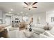 Bright and airy living room with modern furnishings and an open floor plan to the kitchen at 877 Pensive Run, Dacula, GA 30019