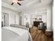 A spacious main bedroom featuring hard floors, a ceiling fan, and ample sitting area at 877 Pensive Run, Dacula, GA 30019