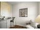 Home office space with granite countertop, white cabinets, and a chair with a pillow at 877 Pensive Run, Dacula, GA 30019