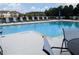 Community pool featuring lounge chairs for relaxing and enjoying the summer sun at 877 Pensive Run, Dacula, GA 30019