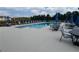 Community pool surrounded by tables with umbrellas for relaxing and enjoying the summer sun at 877 Pensive Run, Dacula, GA 30019