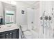 This bathroom features a shower/tub combo and black vanity at 1299 Dunwoody Cv, Atlanta, GA 30338