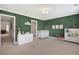 Bright Bedroom includes neutral carpet and green walls with white trim at 1299 Dunwoody Cv, Atlanta, GA 30338