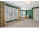 This Bedroom offers a window seat, neutral carpet and green walls at 1299 Dunwoody Cv, Atlanta, GA 30338