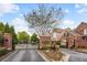 Gated Ashworth community entrance with brick facade and landscaping, offering security and curb appeal at 1299 Dunwoody Cv, Atlanta, GA 30338
