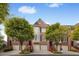 Attractive brick townhome features an attached garage and meticulously maintained front landscaping at 1299 Dunwoody Cv, Atlanta, GA 30338