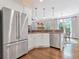 The kitchen features stainless steel appliances, white cabinets and an adjacent eating area at 1299 Dunwoody Cv, Atlanta, GA 30338