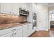 This kitchen features stainless steel appliances, white cabinets and sleek hardware at 1299 Dunwoody Cv, Atlanta, GA 30338