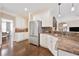 Bright kitchen features stainless steel appliances, brown granite countertops and hardwood floors at 1299 Dunwoody Cv, Atlanta, GA 30338