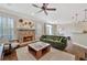 Cozy living room features a stone fireplace, hardwood floors, and comfortable furnishings at 1299 Dunwoody Cv, Atlanta, GA 30338