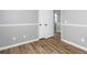 Bedroom featuring modern gray walls, wood flooring, and large closet space at 140 Maplewood Dr, Temple, GA 30179