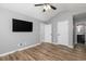 Bedroom features ceiling fan, wood floor, and access to the bathroom at 140 Maplewood Dr, Temple, GA 30179