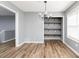 Dining room with hardwood floors, chandelier, and built-in shelves at 140 Maplewood Dr, Temple, GA 30179