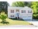 Well-maintained home with a two-car garage, manicured lawn, and inviting curb appeal at 140 Maplewood Dr, Temple, GA 30179