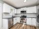 Bright kitchen with stainless steel appliances and white cabinets at 140 Maplewood Dr, Temple, GA 30179