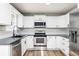 Bright kitchen featuring stainless steel appliances and white cabinets at 140 Maplewood Dr, Temple, GA 30179
