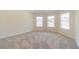 Bright, airy bedroom with neutral carpet and three windows for ample natural light at 1821 Silver Crest Way, Hoschton, GA 30548