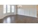 Bright dining room featuring hardwood floors, wainscoting, and ample natural light at 1821 Silver Crest Way, Hoschton, GA 30548
