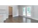 Open living area featuring hardwood floors, access to a pantry, and access to outdoor patio at 1821 Silver Crest Way, Hoschton, GA 30548