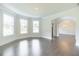 Spacious living room with hardwood floors, large windows, and elegant trim at 1821 Silver Crest Way, Hoschton, GA 30548