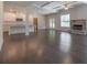 Open-concept living room with a stone fireplace, large windows, and coffered ceilings at 1821 Silver Crest Way, Hoschton, GA 30548
