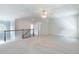 Spacious, well-lit loft area with neutral carpet and a wrought iron railing at 1821 Silver Crest Way, Hoschton, GA 30548