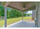 Covered patio with ceiling fan overlooking landscaped yard at 1821 Silver Crest Way, Hoschton, GA 30548