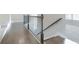 Staircase landing with hardwood floors, wrought iron railing, and carpeted steps at 1821 Silver Crest Way, Hoschton, GA 30548
