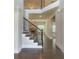 Elegant staircase with dark wood railings, leading to an open-concept living area at 1821 Silver Crest Way, Hoschton, GA 30548