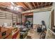 Unfinished basement area featuring exposed wood ceilings, brick wall, and cement floors at 365 Falling Timber Ct, Stockbridge, GA 30281