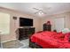 Comfortable bedroom featuring a ceiling fan, dresser, and mounted flat screen television at 365 Falling Timber Ct, Stockbridge, GA 30281