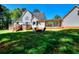 Large backyard features a spacious deck, a fire pit with chairs, and a well-maintained lawn at 377 Lakeview Dr, Newborn, GA 30056