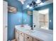 Stylish bathroom with blue walls, modern lighting, and neutral vanity at 377 Lakeview Dr, Newborn, GA 30056