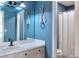 Bathroom featuring a large mirror, white vanity, and nautical decor at 377 Lakeview Dr, Newborn, GA 30056