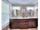 Bright bathroom with dual sinks, granite countertops, and wood cabinetry offering ample storage at 377 Lakeview Dr, Newborn, GA 30056