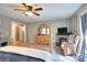 Inviting bedroom with a four-poster bed, fireplace, sitting area, and plenty of natural light at 377 Lakeview Dr, Newborn, GA 30056