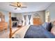 Warm bedroom with a fireplace, sitting area, and a wooden four-poster bed bathed in natural light at 377 Lakeview Dr, Newborn, GA 30056
