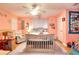 Charming bedroom with peach colored walls, ceiling fan, and a white wood crib at 377 Lakeview Dr, Newborn, GA 30056