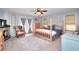 Spacious bedroom with a four-poster bed, fireplace, sitting area, and access to a private outdoor space at 377 Lakeview Dr, Newborn, GA 30056