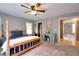 Charming bedroom boasts a wooden four-poster bed and desk, neutral walls, and plush carpeting at 377 Lakeview Dr, Newborn, GA 30056