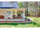 Relaxing covered patio with ceiling fans offering a view of the landscaped yard at 377 Lakeview Dr, Newborn, GA 30056