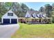 Charming two-story farmhouse featuring a welcoming front porch and two-car garage at 377 Lakeview Dr, Newborn, GA 30056