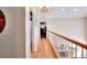 Hallway with wood floors and white railings, leading to various rooms at 377 Lakeview Dr, Newborn, GA 30056