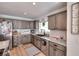 Updated kitchen featuring gray cabinets, stainless-steel appliances, and granite countertops at 377 Lakeview Dr, Newborn, GA 30056