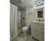 Bright bathroom with tiled shower, white vanity and marble tile floors at 760 Whitehall Way, Roswell, GA 30076