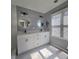 Bathroom with white double vanity, backlit mirrors, and natural lighting at 760 Whitehall Way, Roswell, GA 30076