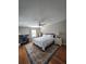 Bedroom with ceiling fan, wood floors, and neutral decor at 760 Whitehall Way, Roswell, GA 30076