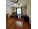 Cozy bedroom features a ceiling fan, hardwood floors, and a comfortable recliner at 760 Whitehall Way, Roswell, GA 30076