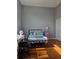 Bedroom with hardwood flooring and neutral walls complemented by modern furniture at 760 Whitehall Way, Roswell, GA 30076